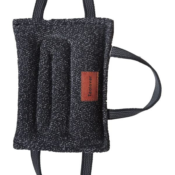 Black textured bag with a brown label on a white background