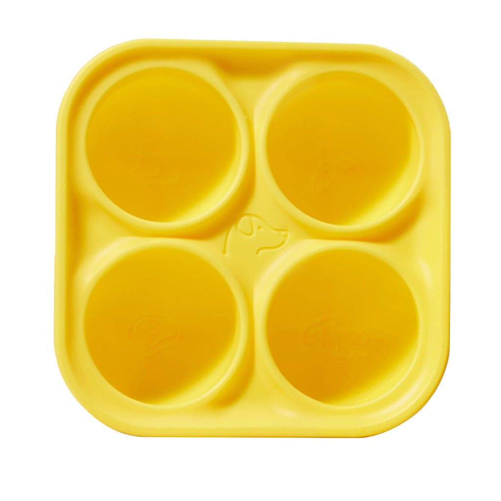 Yellow silicone mold with four circular compartments on a white background