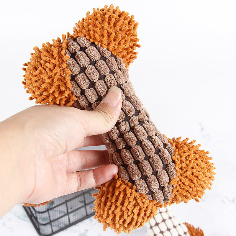 Hand holding a textured brown and orange woven item against a white background