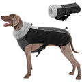 Dog wearing a black and gray winter coat with a detachable gray fur-lined hood.
