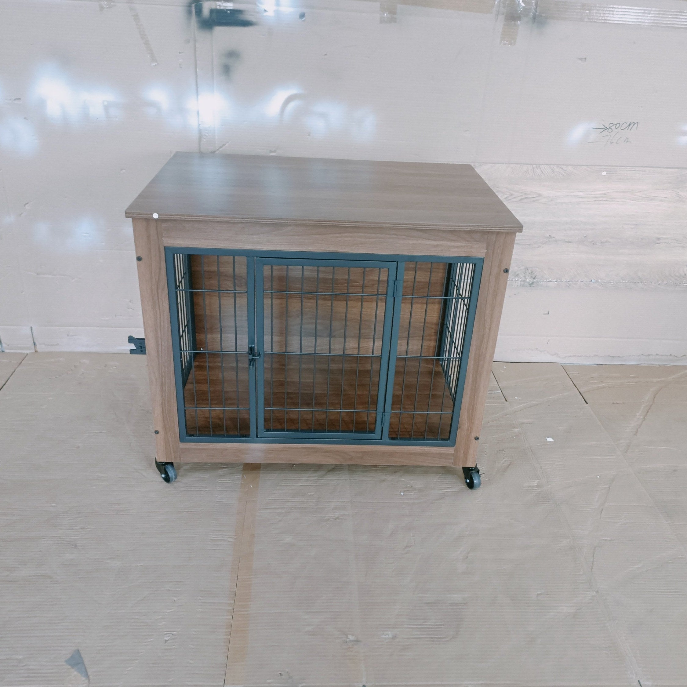 Dog crate with wooden frame and metal bars on a tiled floor
