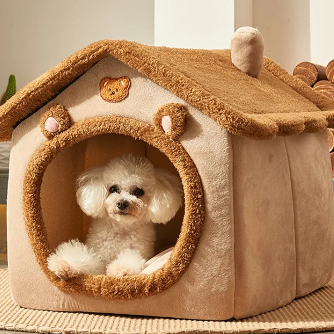 Small white dog inside a cozy beige pet house with brown roof