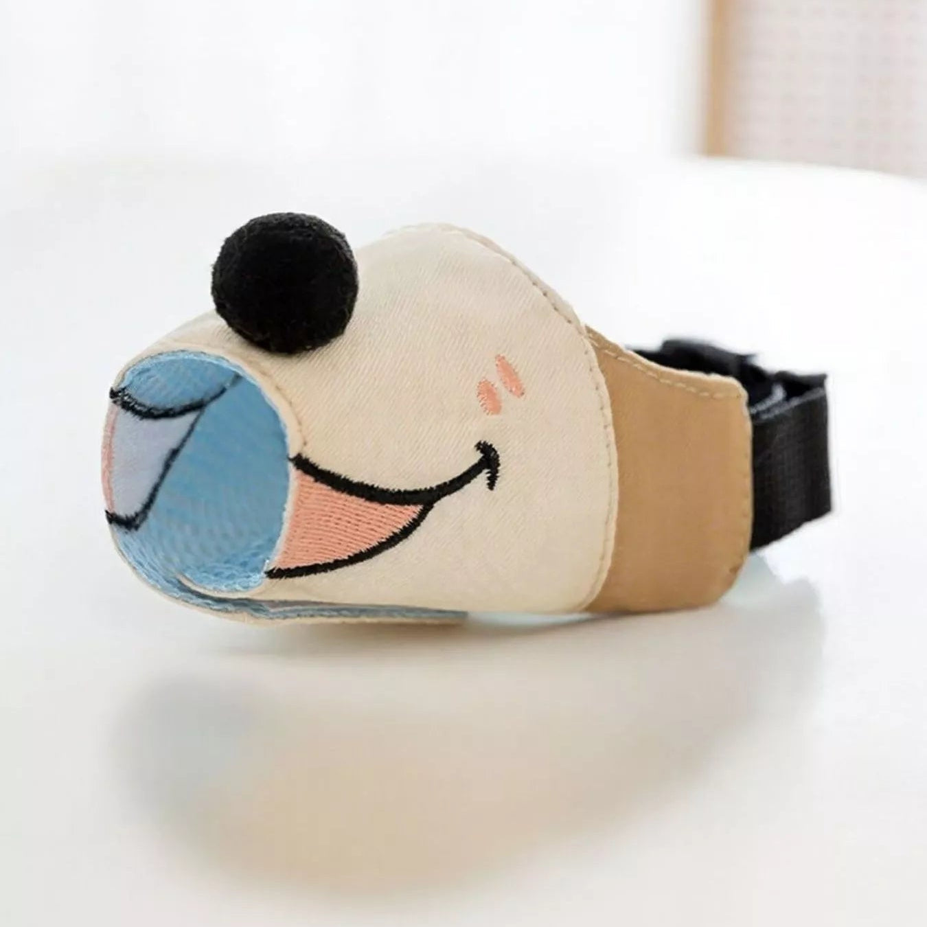 Dog toy with a happy face design on a white surface