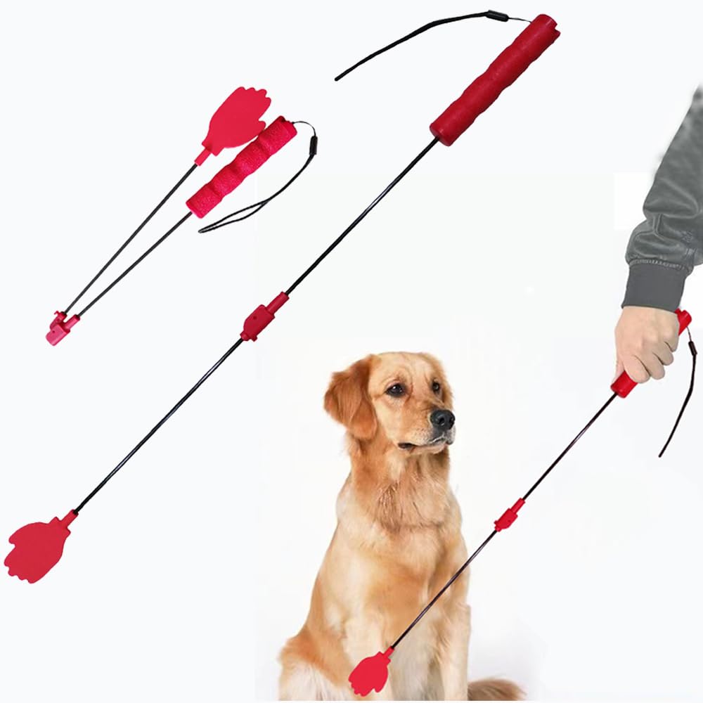 Dog training tool with red handles and black shaft held by a person, next to a dog on a white background.