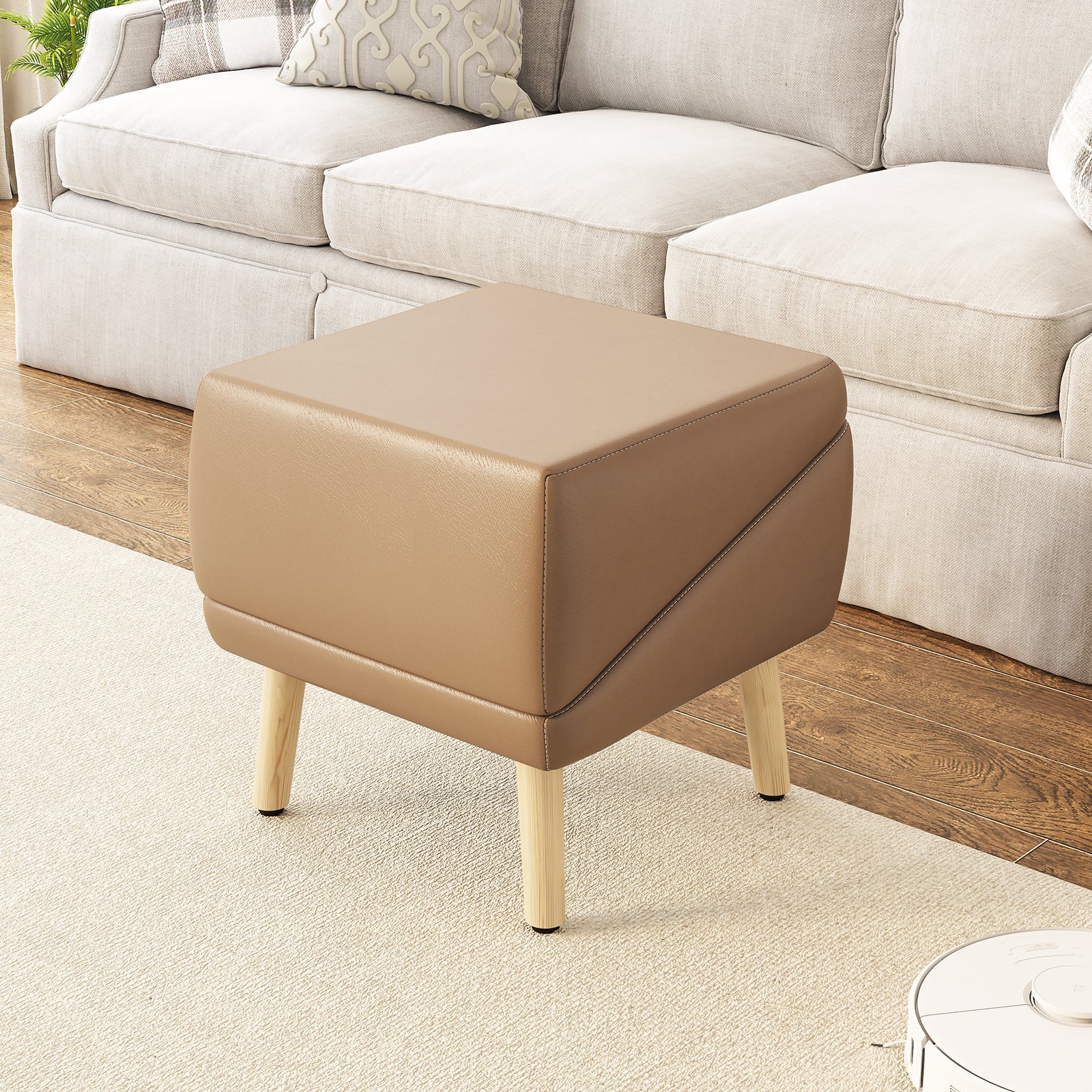 Beige ottoman in a living room setting with a beige sofa.