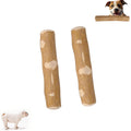 Two wooden dog chew toys with a dog peeking over one of them on a white background.
