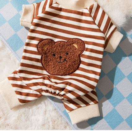 Brown and white striped outfit with a teddy bear patch on a checkered surface