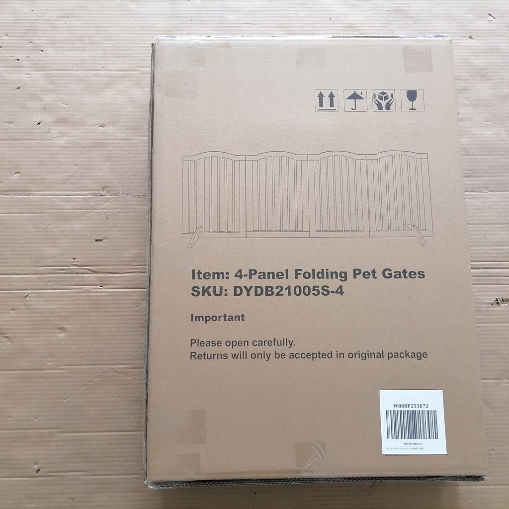 Cardboard box with pet gate packaging on a wooden surface