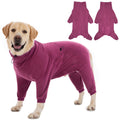 Dog wearing a purple onesie with detachable sleeves on a white background