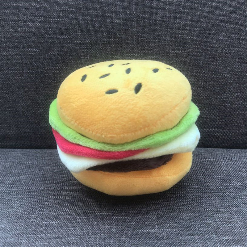 Plush toy shaped like a hamburger on a dark fabric background