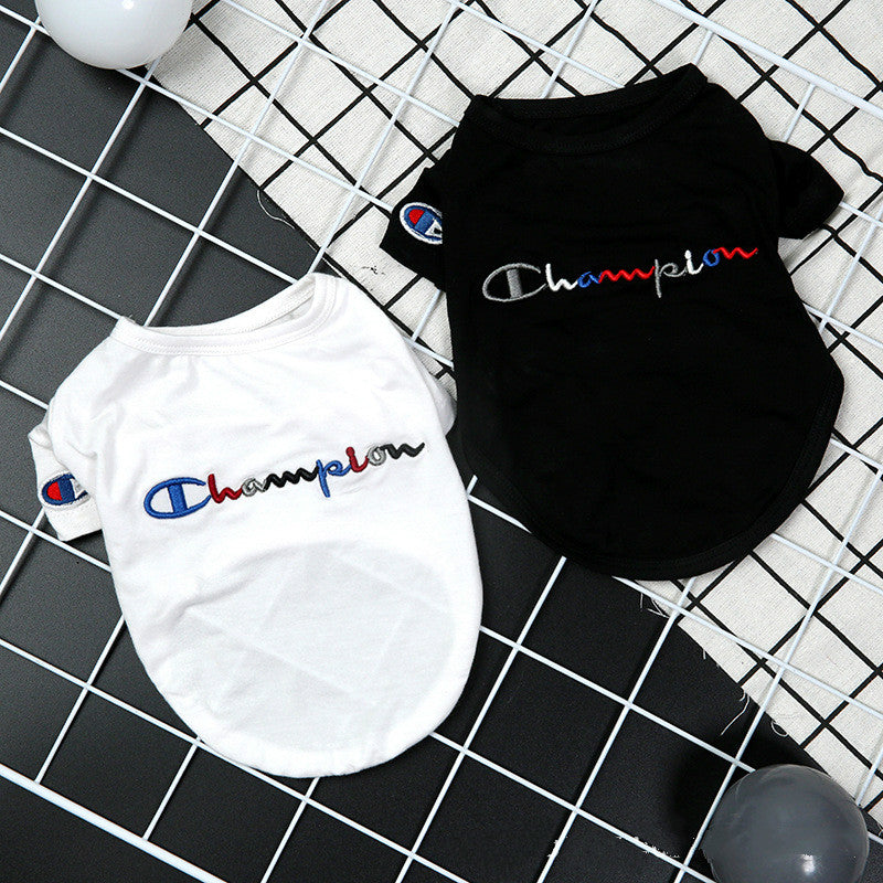 White and black pet shirts with Champion logo on a grid background
