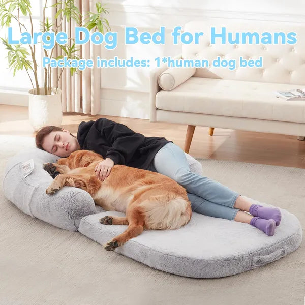 Person lying on a large dog bed with a dog, with text indicating it's a 'Large Dog Bed for Humans'.