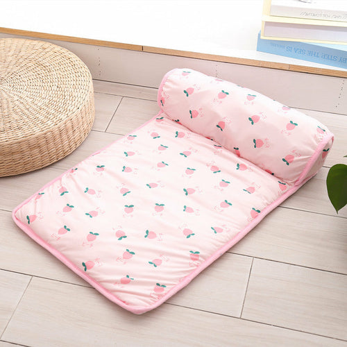Pink mattress with cherry pattern on a wooden floor