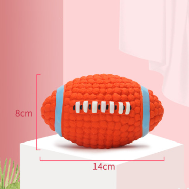 Red textured football-shaped toy with measurements on a pink background