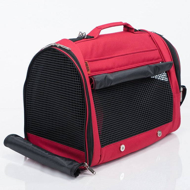 Red pet carrier with black mesh sides on a white background