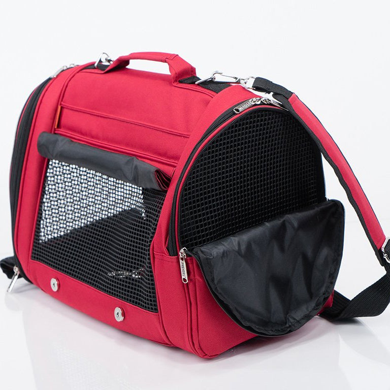 Red pet carrier with black interior on a white background