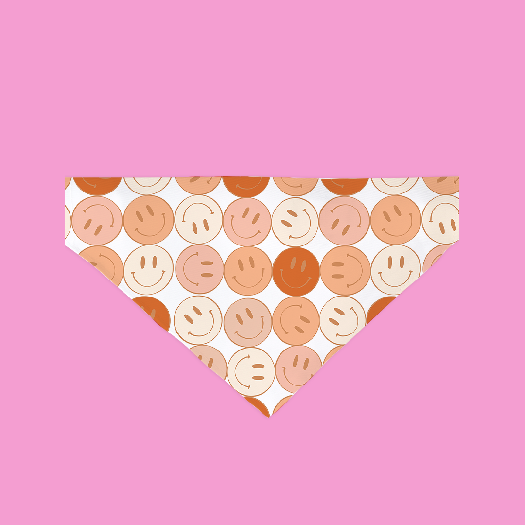 Patterned bandana with smiley face design on a pink background