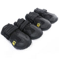 Set of black pet boots with yellow paw prints on a white background