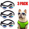 Three pairs of dog sunglasses with rainbow reflection and a dog wearing a green shirt on a white background.
