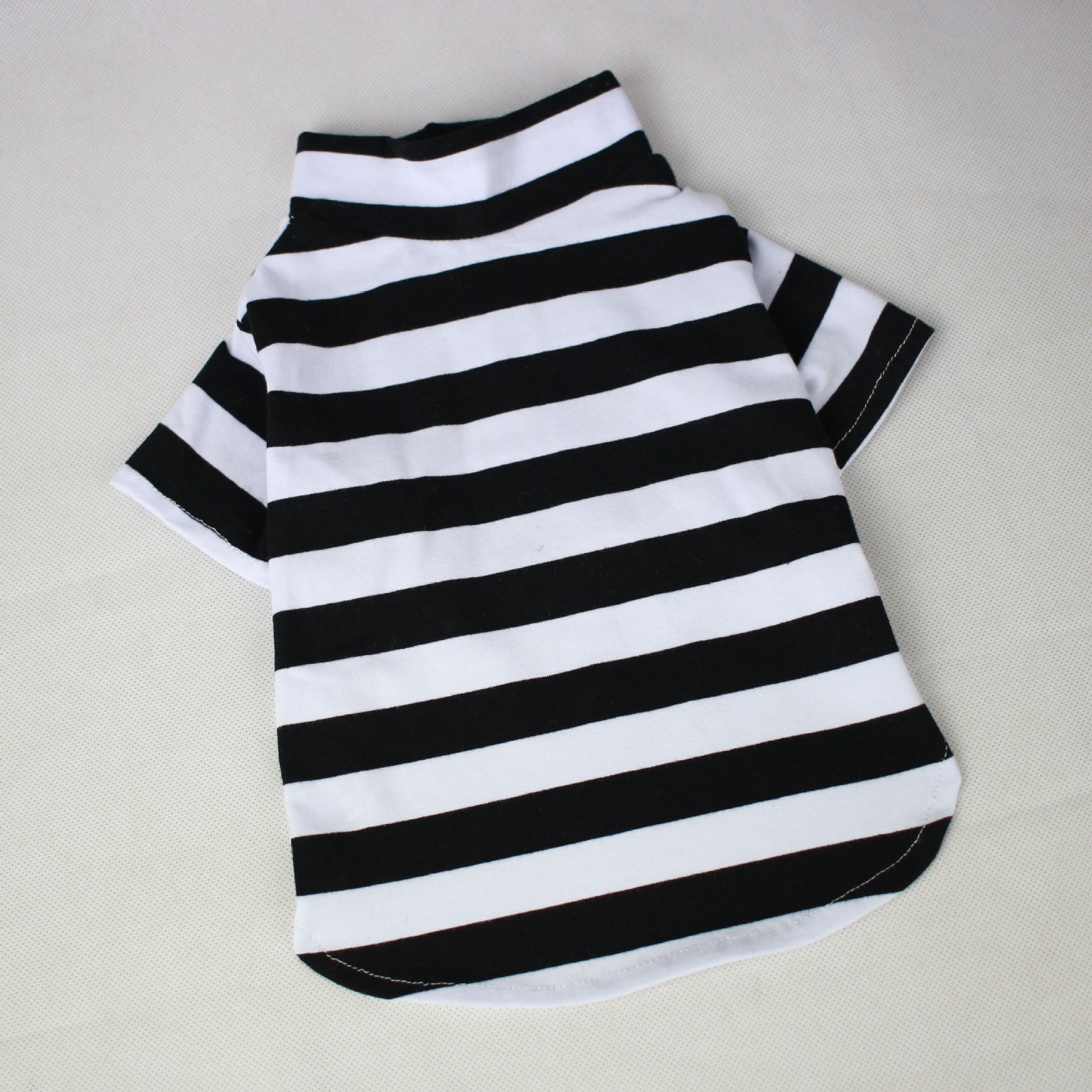 Black and white striped pet shirt on a light gray background