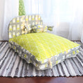 Green and gray patterned pet bed on a striped rug