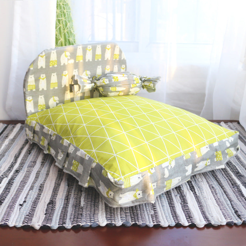 Green and gray patterned pet bed on a striped rug