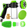 Green and black garden hose nozzle set with various attachments on a white background
