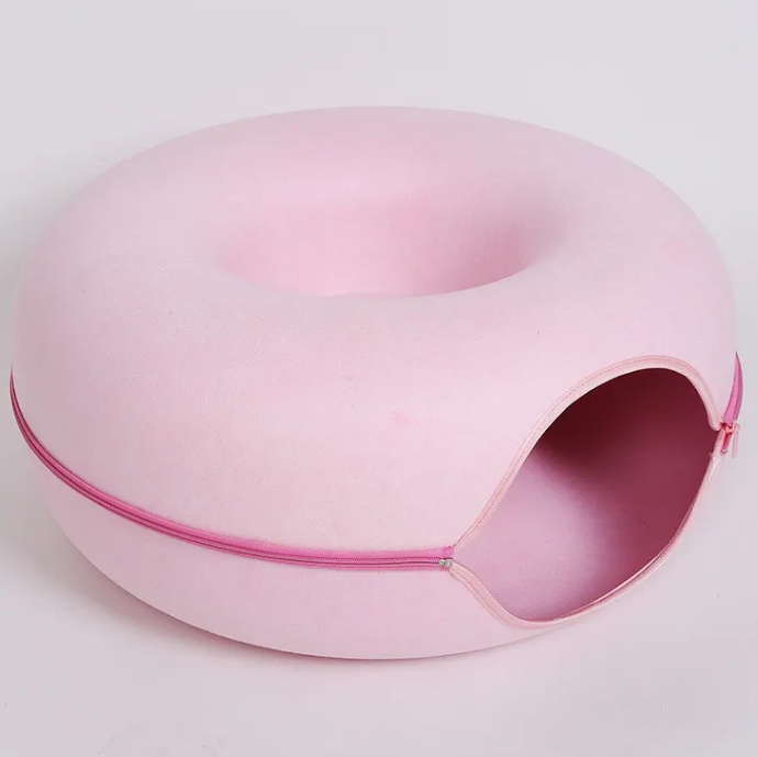 Pink pet bed with a zipper on a light gray background