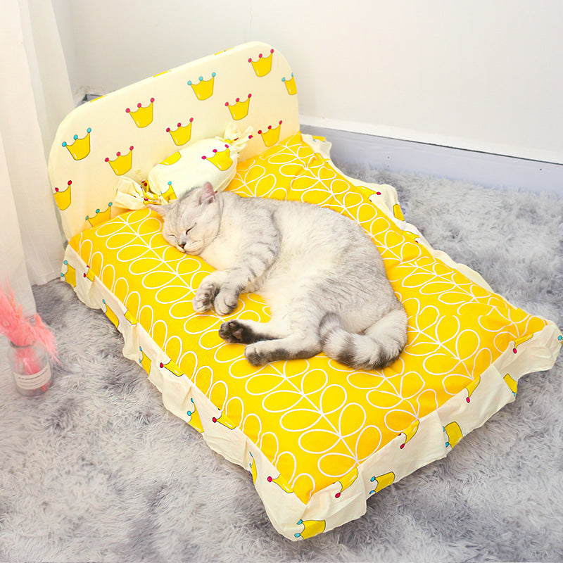 Cat sleeping on a yellow pet bed with a patterned design