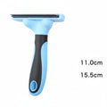 Blue and black pet grooming brush with measurements on a dark background