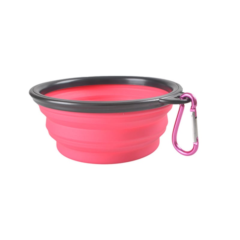 Pink collapsible pet bowl with black interior and pink carabiner on a white background