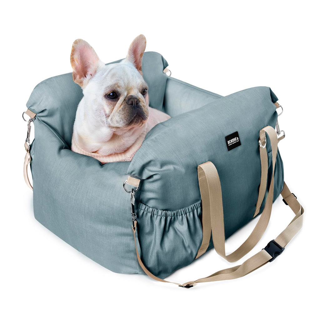 Dog lying in a blue pet carrier with a visible brand logo on a white background