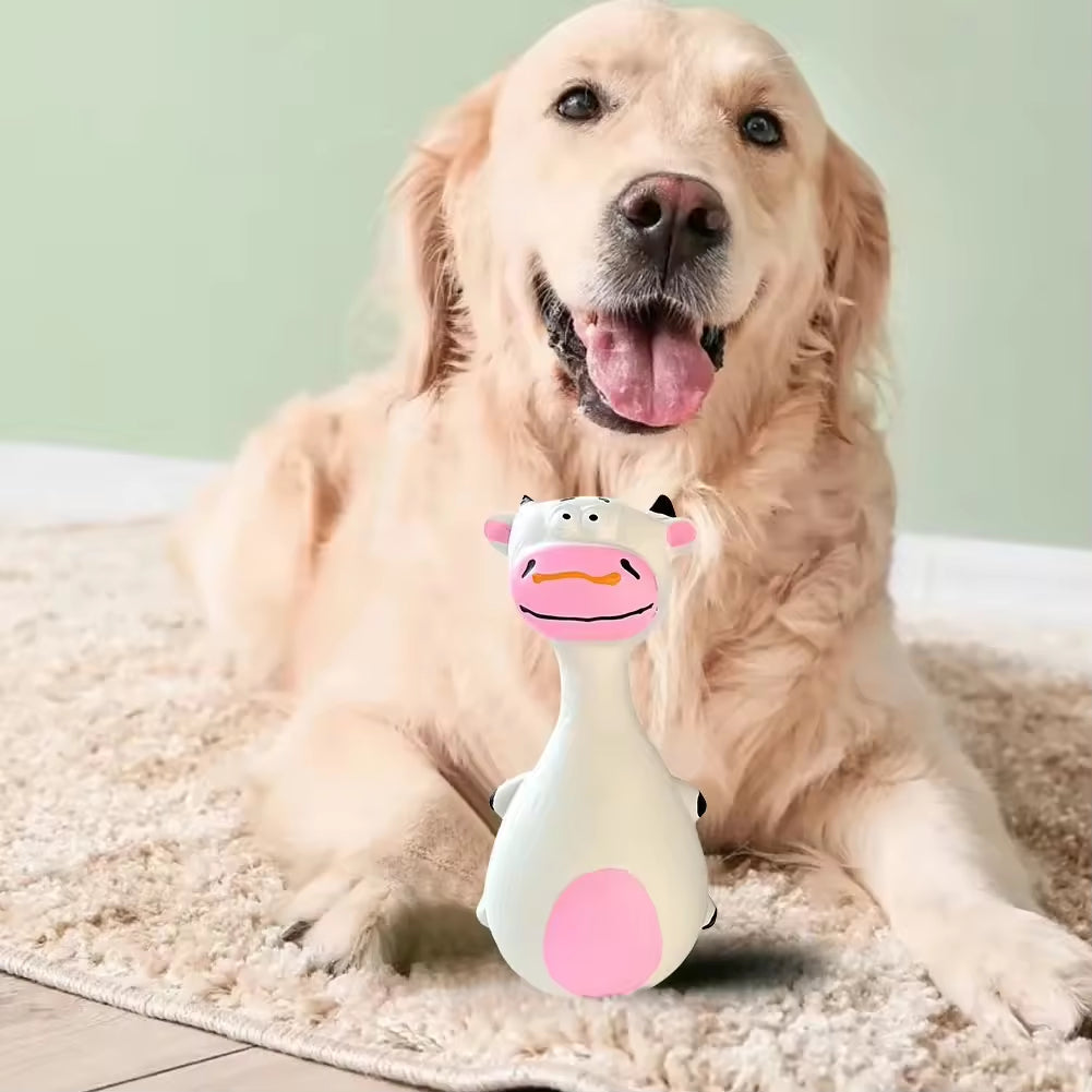 Dog playing with a cow-shaped toy on a carpeted floor.