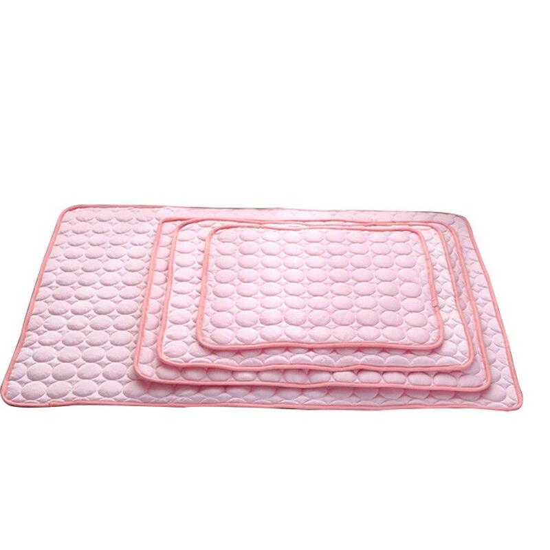 Set of three pink quilted mats on a white background