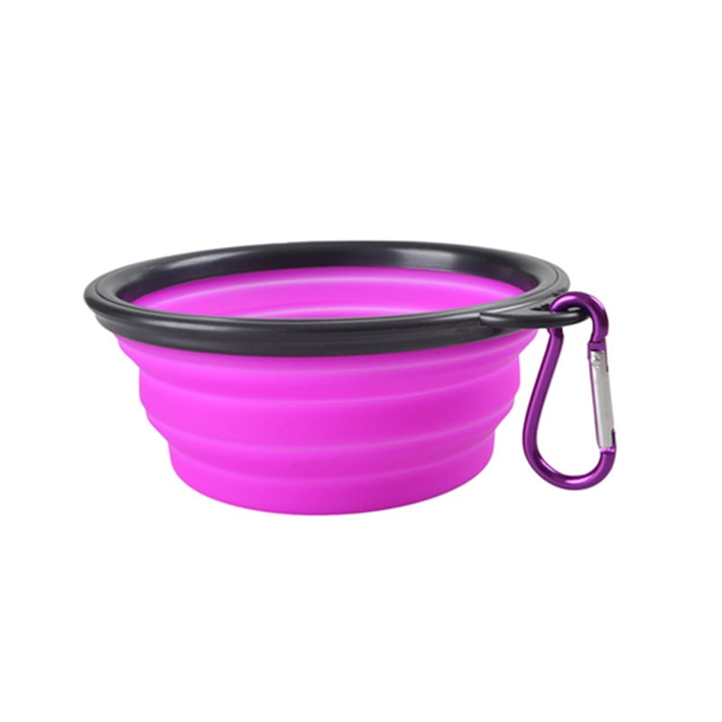 Purple silicone dog bowl with black rim and purple carabiner on a white background