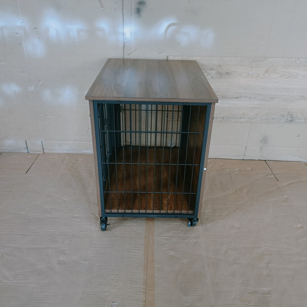 Metal cage on wheels against a plain wall with a tiled floor.