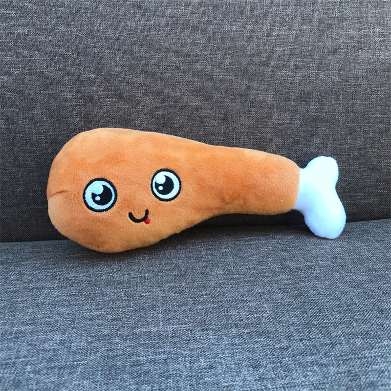 Plush toy shaped like a chicken drumstick with a face on a gray background
