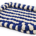 Blue and white striped pet bed on a white background