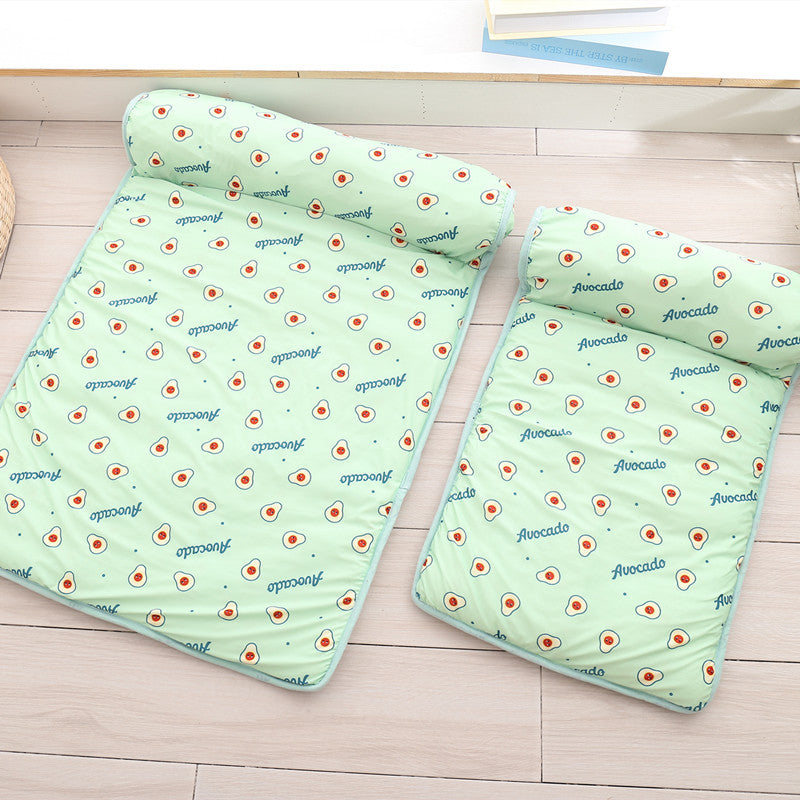 Two green baby blankets with avocado pattern on a wooden floor.