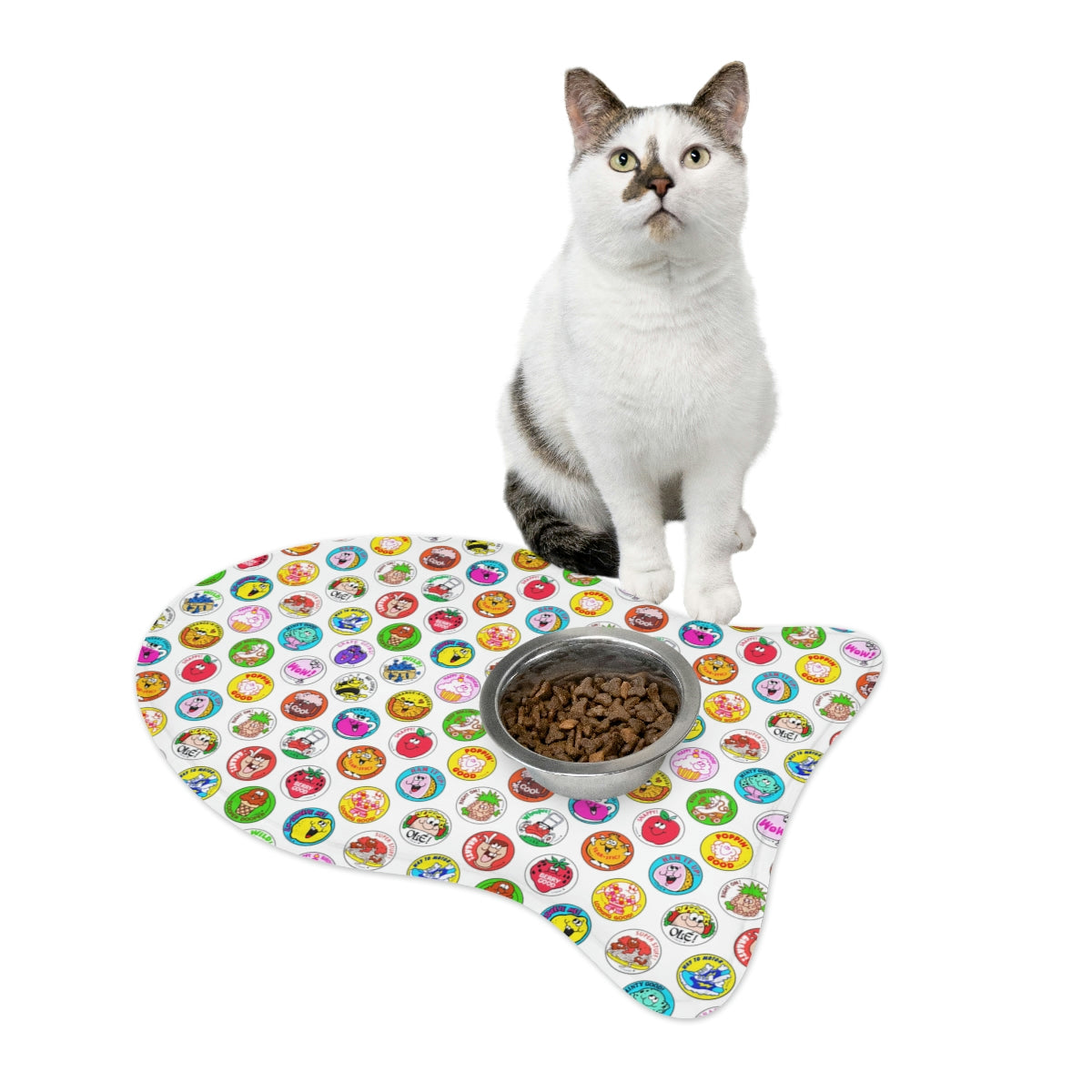 Cat sitting on a colorful pet mat with a bowl of food
