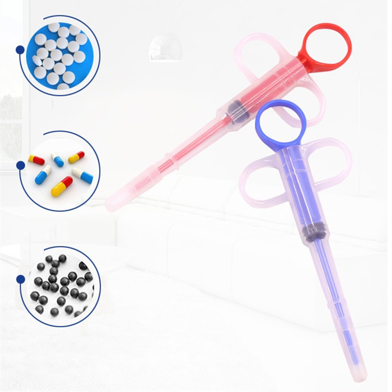 Two syringes with colorful capsules on a white background