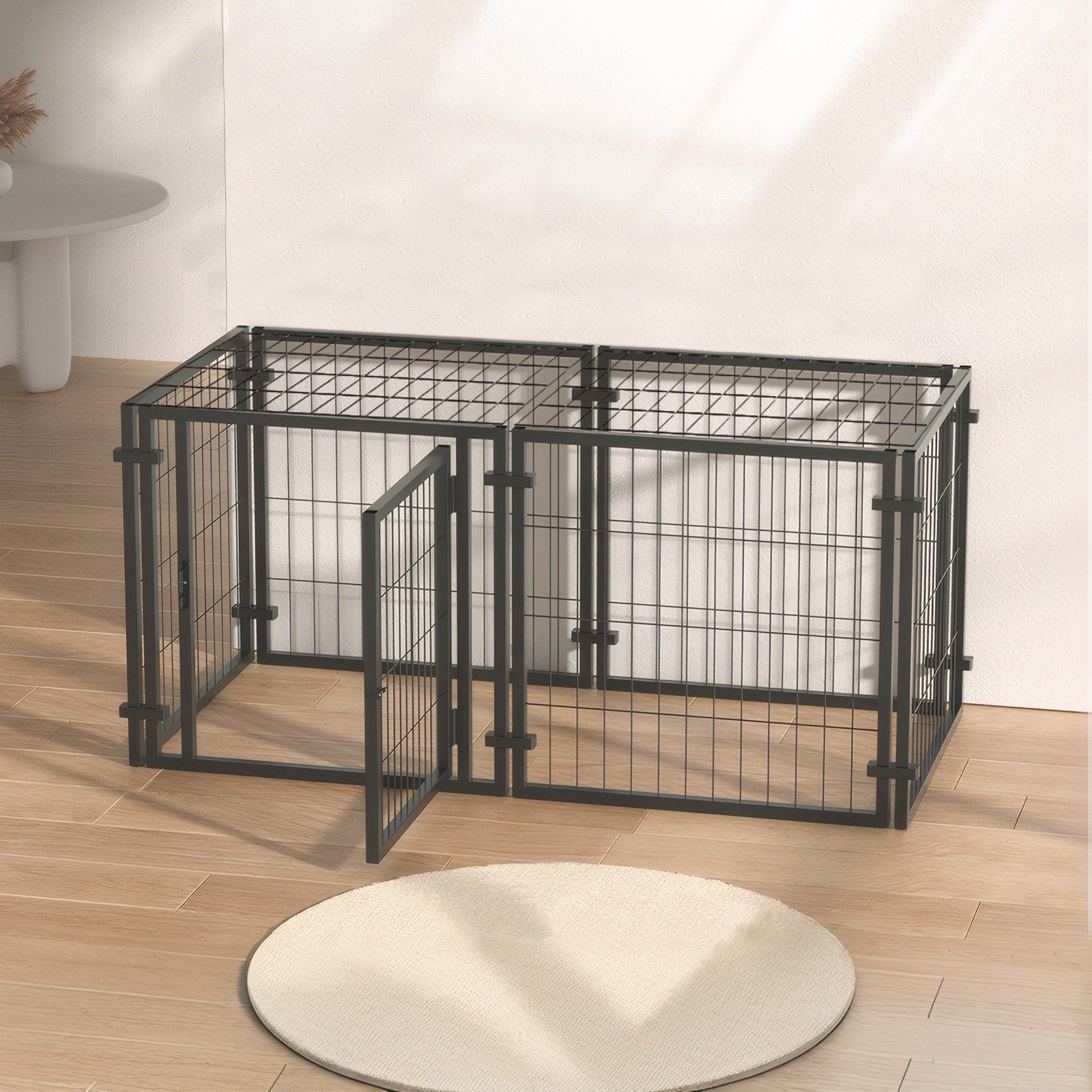 Black metal pet playpen on a wooden floor with a white wall background