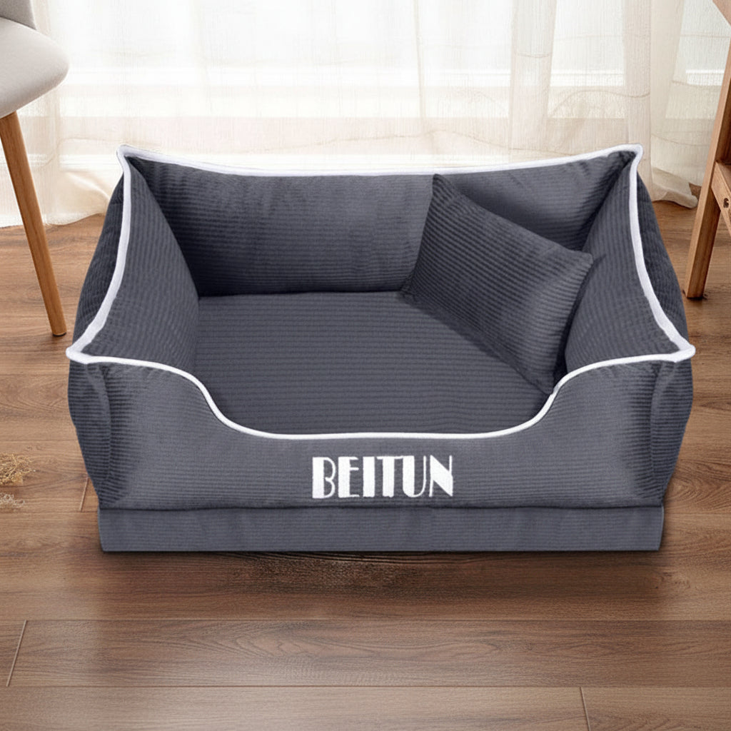 Gray pet bed with white piping and 'BEITUN' branding on a wooden floor.