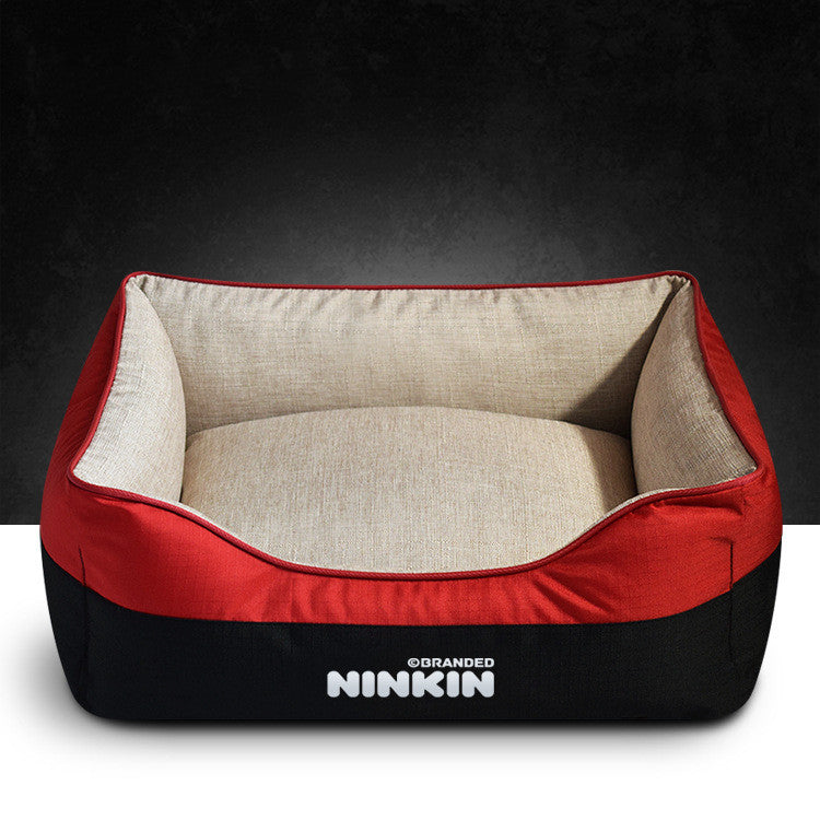Red and black pet bed with beige interior on a dark background
