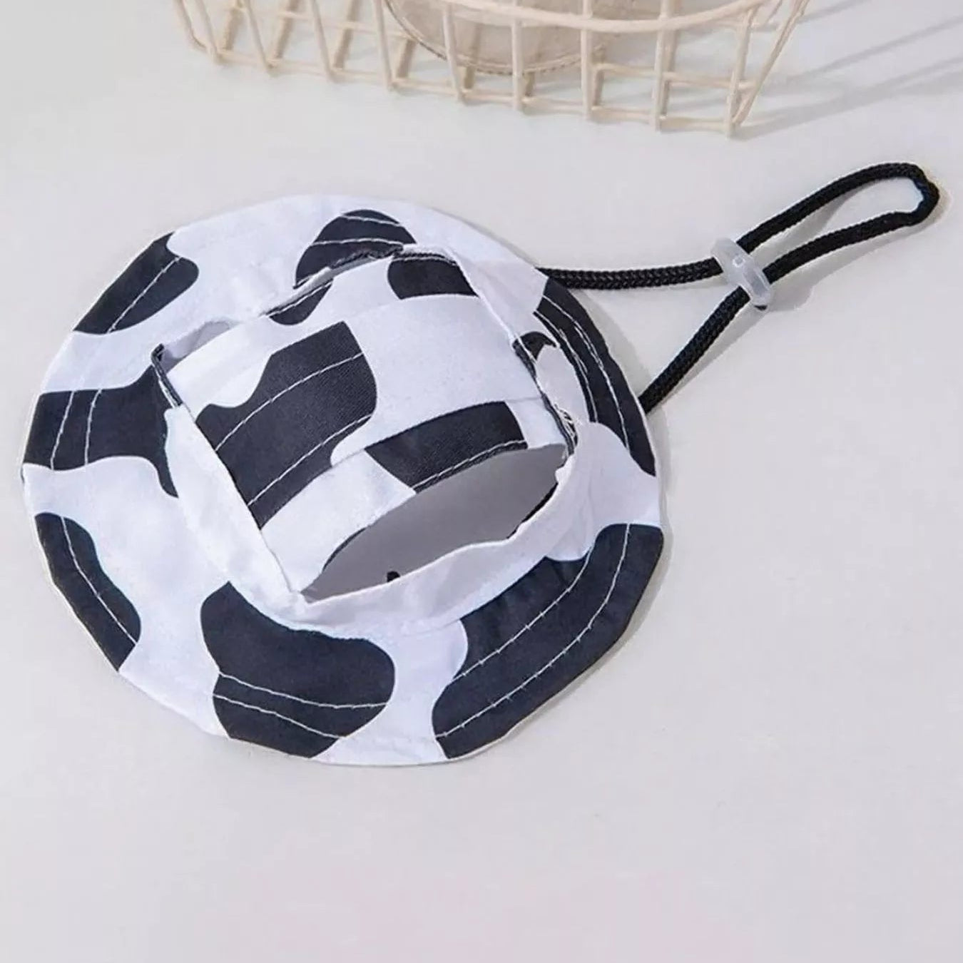 White face mask with black pattern on a light gray background