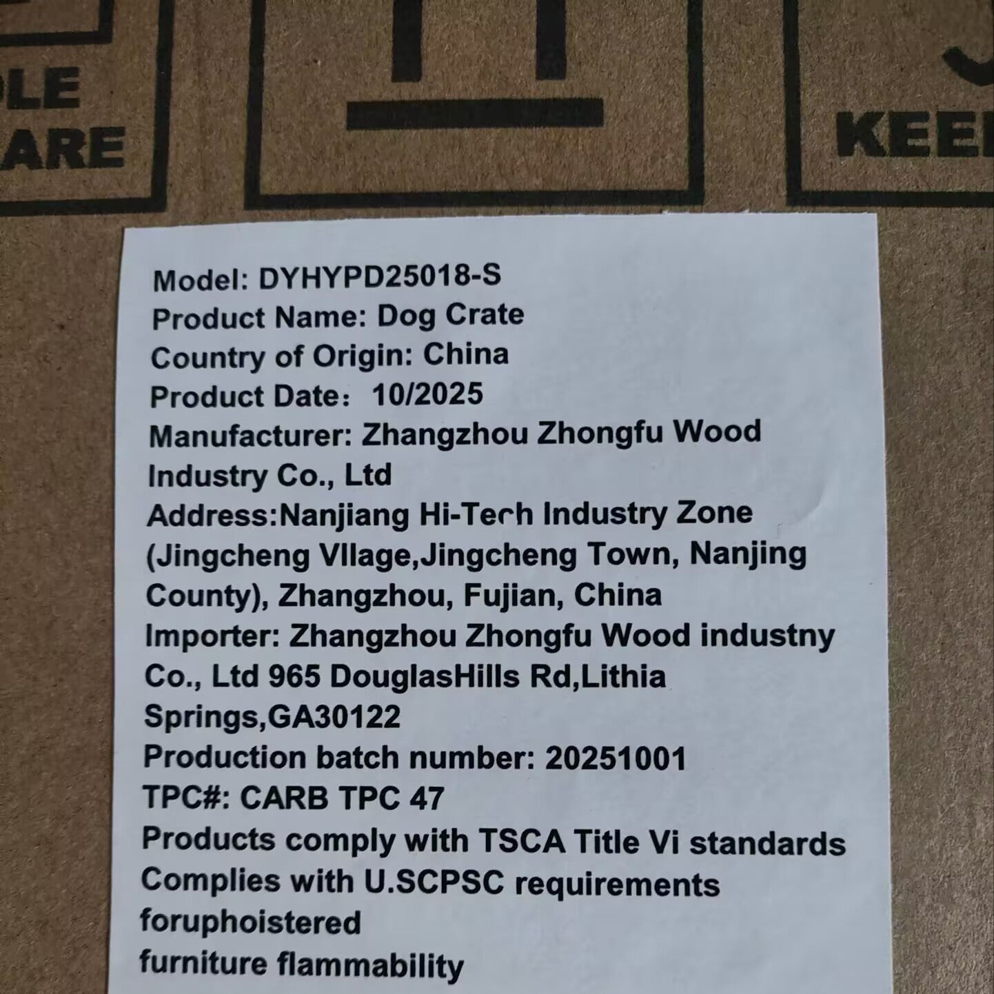 Product label on a cardboard surface with text details.
