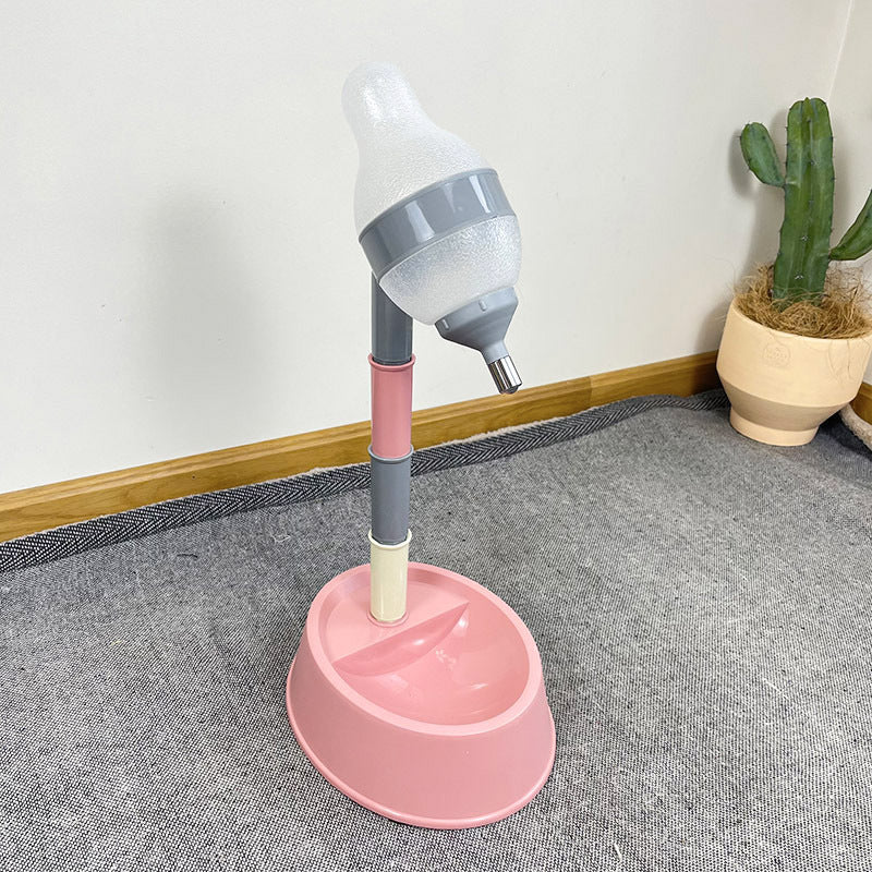 Pink and gray plastic device on a gray floor with a plant in the background