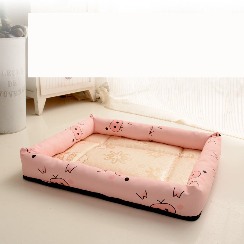 Pink pet bed with cartoon designs on a light surface