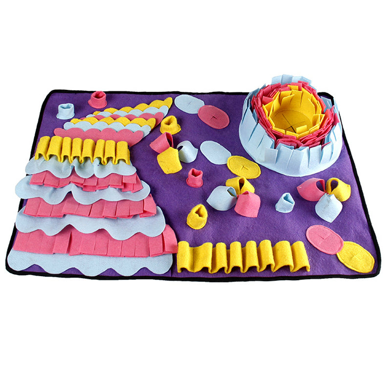Colorful play mat with toy cake and accessories on a white background