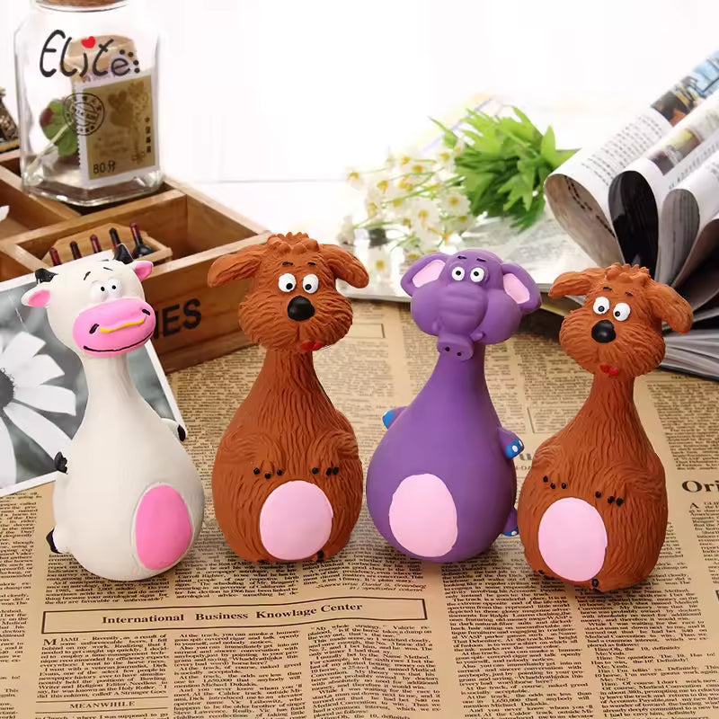 Four colorful animal-shaped stress balls on a newspaper background